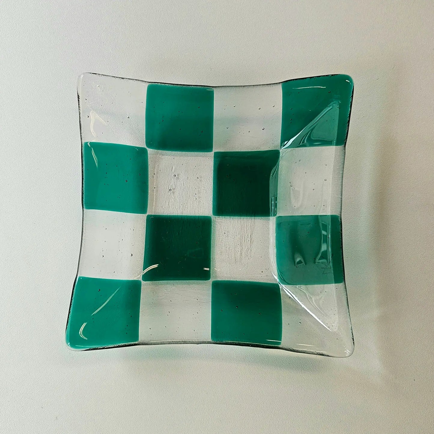 Green and transparent checkered fused glass dish.