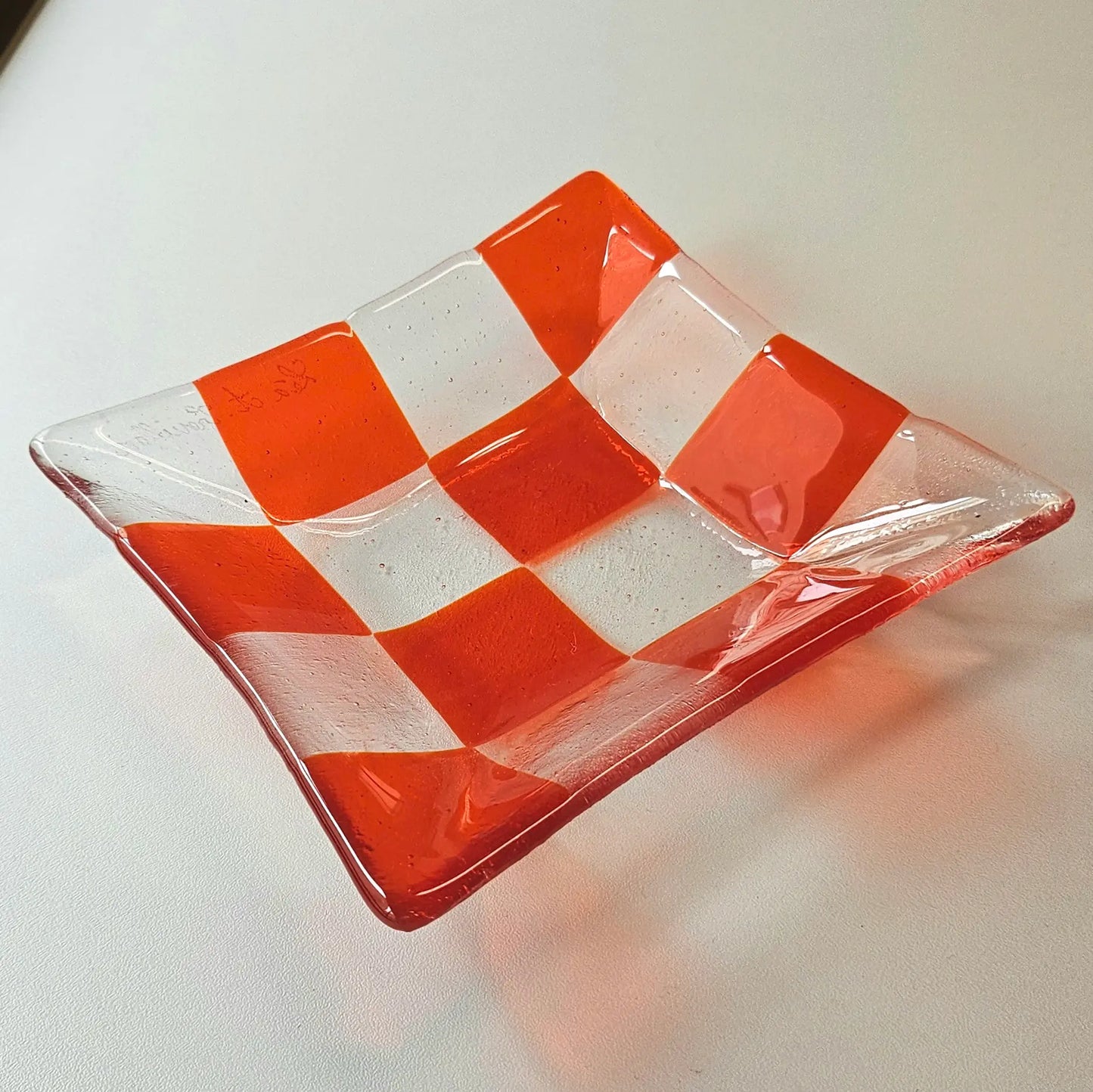 Bright red fused glass dish with a checkered pattern, perfect for your little treasures.